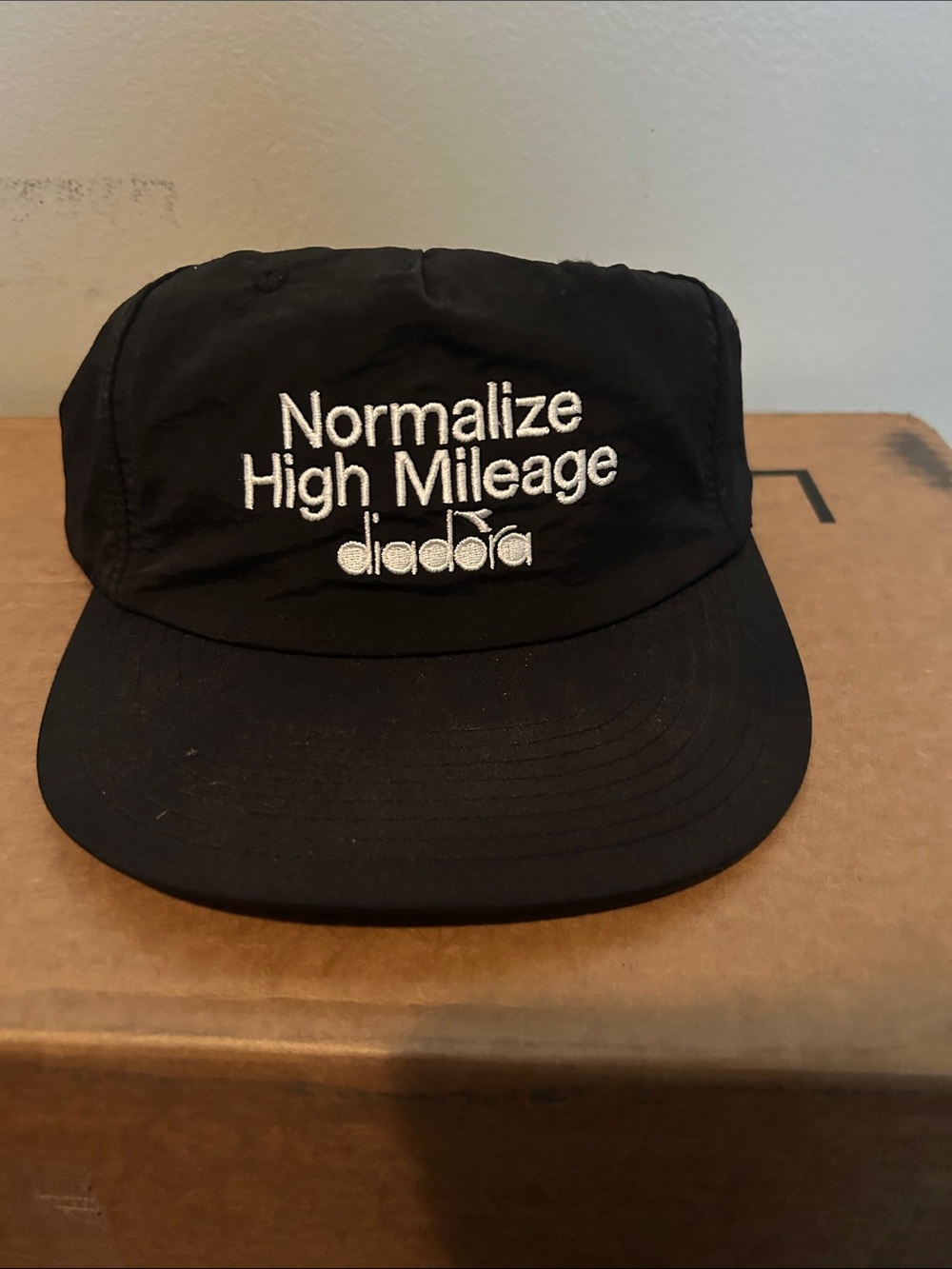 Diadora Black Cap with White 'Normalize High Mileage' Embroidery